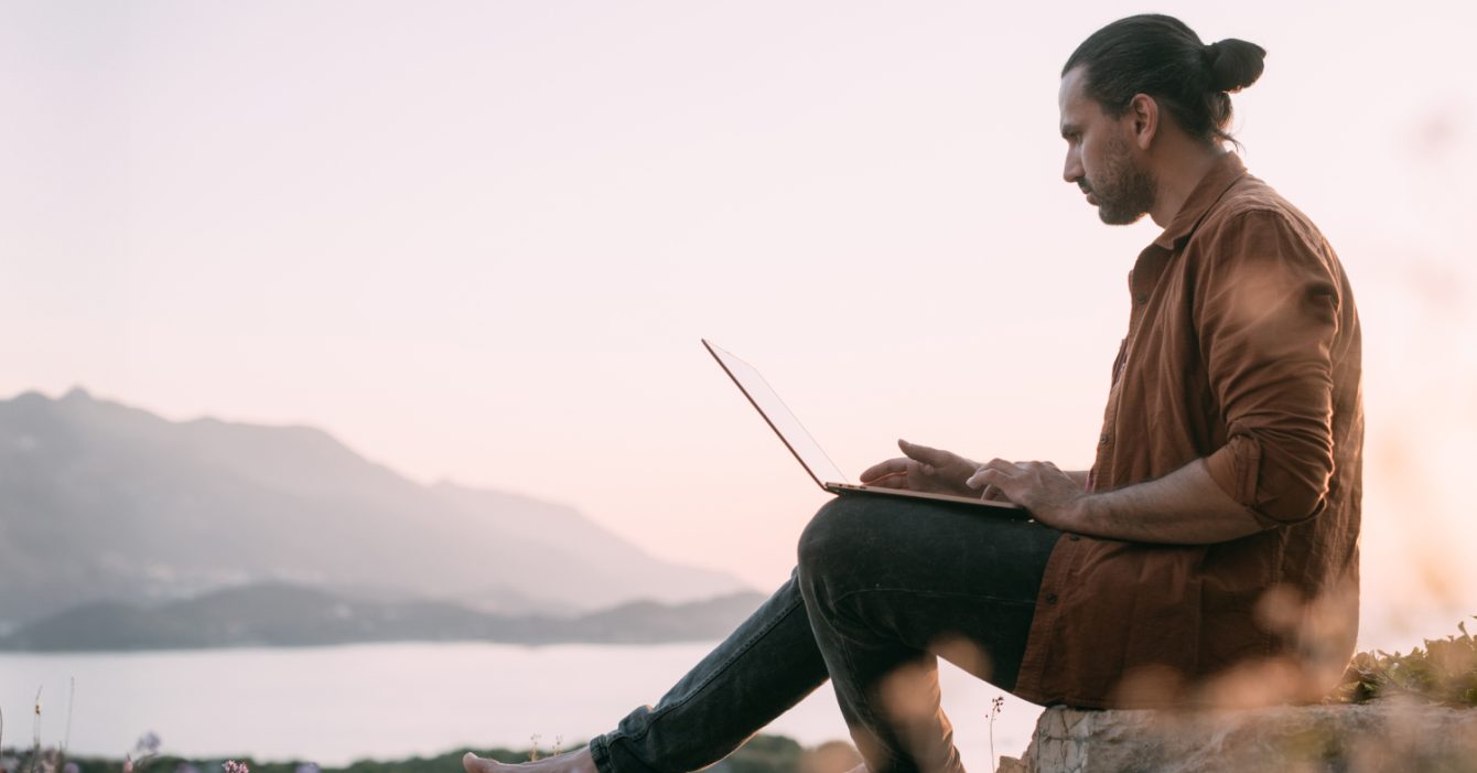 A,Young,Caucasian,Man,Remotely,Works,With,A,Laptop,In