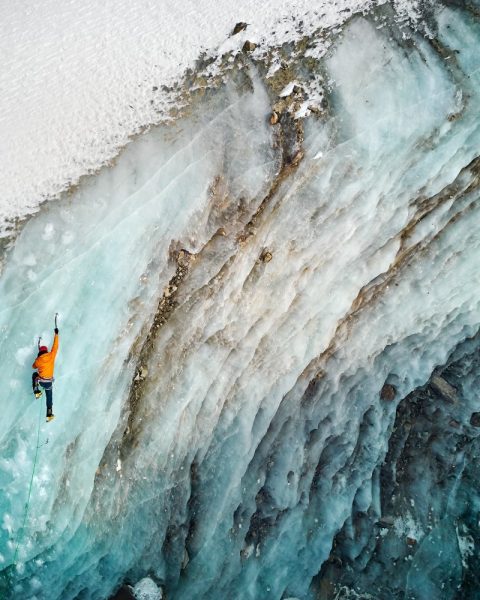 Aerial,Drone,View,Of,Athlete,In,Orange,Jacket,Ice,Climbing Aerial,Drone,View,Of,Athlete,In,Orange,Jacket,Ice,Climbing